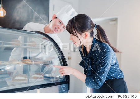 Young woman choosing sweets at the shop Young woman choosing sweets at the shop 96689409