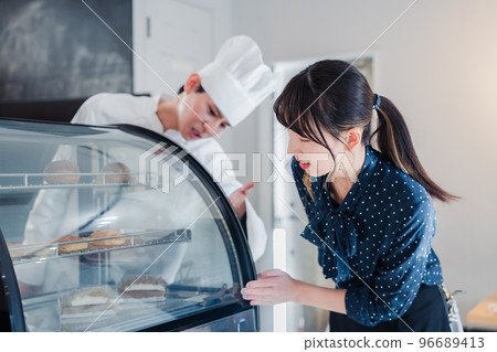 Young woman choosing sweets at the shop Young woman choosing sweets at the shop 96689413