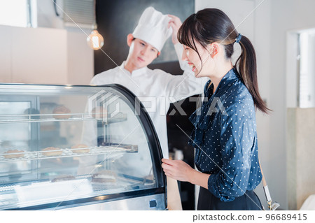 Young woman choosing sweets at the shop Young woman choosing sweets at the shop 96689415
