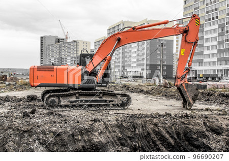 Orange excavator on a construction site 96690207