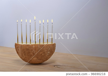Creative Hanukkah menorah on a wooden table. 96690218
