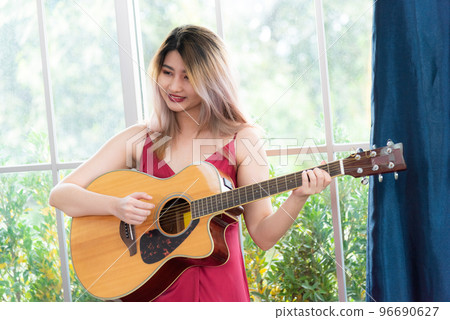 Beautiful young asian woman playing acoustic guitar . fashion lifestyle 96690627