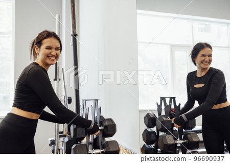 Strong brunette female doing crossfit workout 96690937