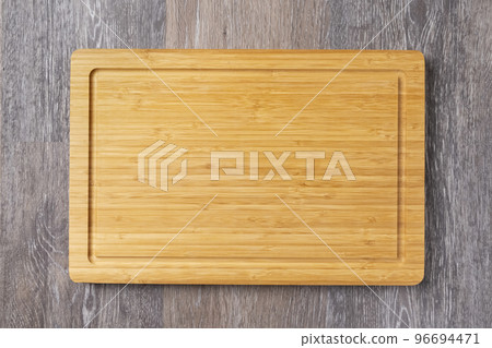 Empty cutting board on the kitchen table 96694471