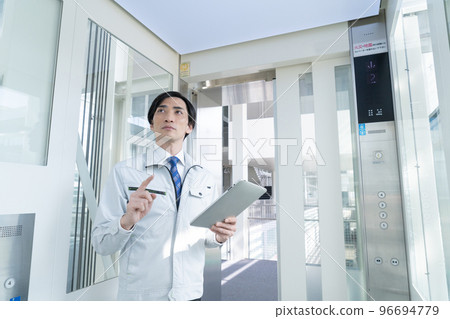 Men in work clothes inspecting elevators Men in work clothes inspecting elevators 96694779