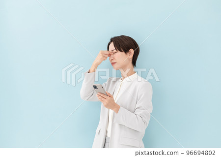 Business smartphone worried woman blue back Business smartphone worried woman blue back 96694802