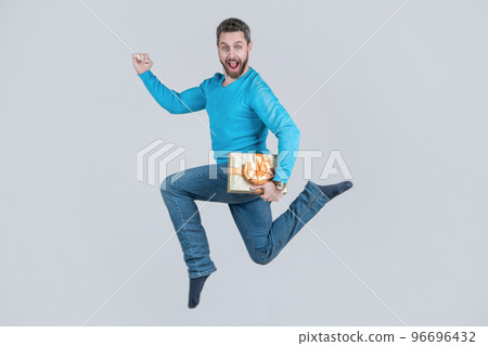 jumping handsome man with present box. businessman giving birthday gift. energetic unshaven man 96696432
