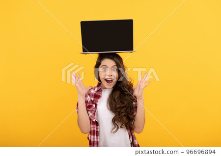 amazed smart kid with laptop on head presenting school online lesson, elearning 96696894