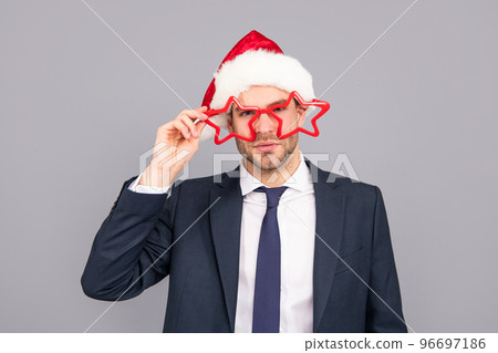 having fun. happy new year. merry christmas. businessman in suit and santa claus hat. 96697186