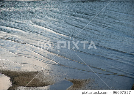 Calm waves lapping the shore Calm waves lapping the shore 96697837