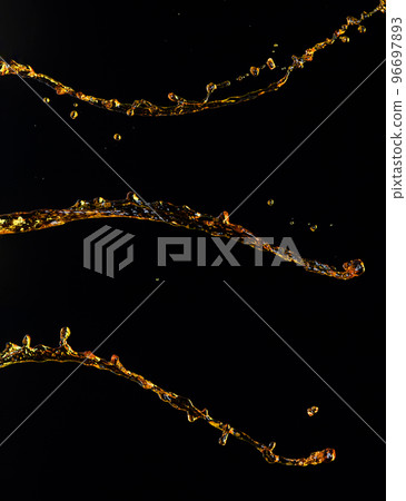 Orange, lemon juice or oil lubricant splash, liquid gold yellow drink drops. Fruit beverage water elements in line form . Fresh splashing and flowing jets, black background isolated freeze motion 96697893