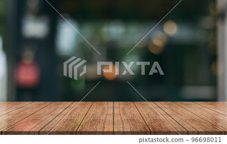 Empty wooden table top with lights bokeh on blur restaurant background.	 96698011