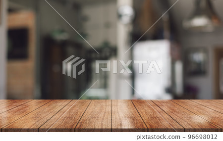 Empty wooden table top with lights bokeh on blur restaurant background.	 96698012