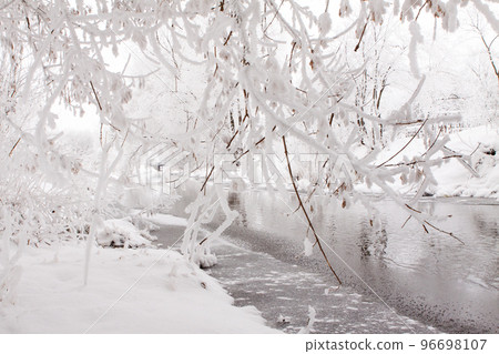 Snow-covered landscape of open spaces near the river. Snowy weather 96698107