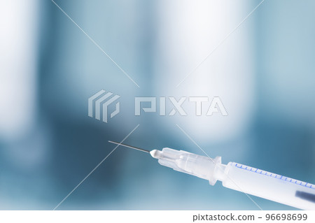 Syringe with injection over blue background. Vaccination or beauty therapy concept. Syringe with injection over blue background. Vaccination or beauty therapy concept. 96698699