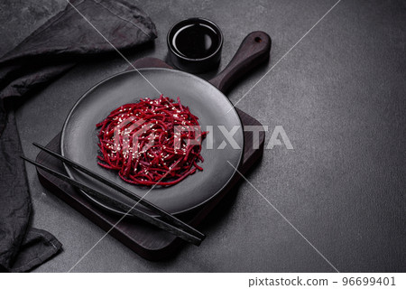 Tasty spicy Korean beet with spices and herbs on a dark concrete background 96699401