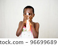 little boy playing with bottle of liquid soap 96699689