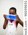 little boy hiding his face with a bottle of liquid soap 96699691