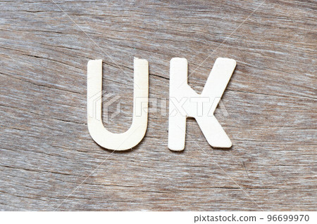 Alphabet letter in word UK  (abbreviation of united kingdom) on wood background 96699970