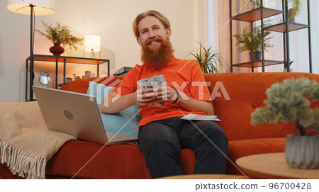 Rich happy man counting money cash and use laptop calculator, calculate domestic income earnings Rich happy man counting money cash and use laptop calculator, calculate domestic income earnings 96700428