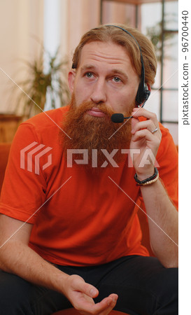 Bearded man freelance worker call center, support service operator helpline having talk with client Bearded man freelance worker call center, support service operator helpline having talk with client 96700440