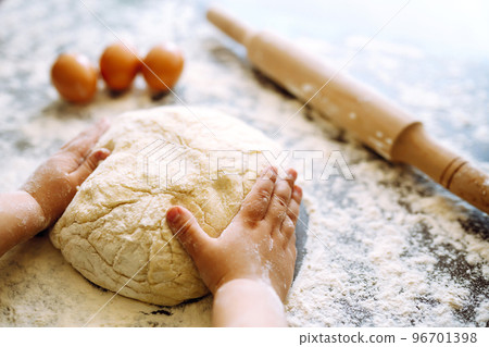Children hands kneading dough for baking. Kids hands, some flour, wheat dough. Cookies for Christmas. 96701398