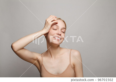 Pretty nice woman holding her head with a laugh looking to the side. Perfect woman 96701502