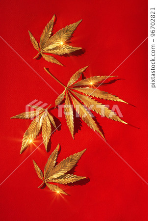 Abstract red christmas background with golden cannabis, marijuana leaves with shine. Abstract red christmas background with golden cannabis, marijuana leaves with shine. 96702821