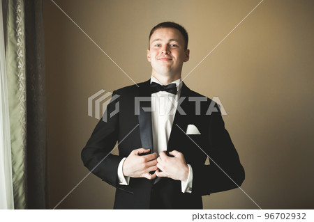 Beautiful man, groom posing and preparing for wedding Beautiful man, groom posing and preparing for wedding 96702932