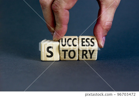 Success story symbol. Concept words Success story on wooden cubes. Businessman hand. Beautiful grey table grey background. Business and Success story concept. Copy space. 96703472