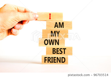 I am my own best friend symbol. Concept words I am my own best friend on wooden blocks on a beautiful white table white background. Businessman hand. Business i am my own best friend concept. 96703514
