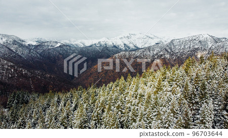 Winter landscape with snow covered mountain peaks. Winter landscape with snow covered mountain peaks. 96703644