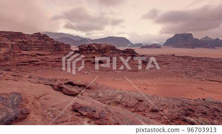 Red orange Mars like landscape in Jordan Wadi Rum desert, mountains background, overcast morning. This location was used as set for many science fiction movies 96703913