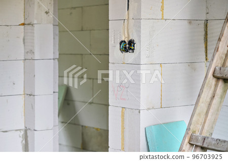 New house empty wall built from AAC - autoclaved cellular concrete, boxes with cables for electric sockets visible New house empty wall built from AAC - autoclaved cellular concrete, boxes with cables for electric sockets visible 96703925
