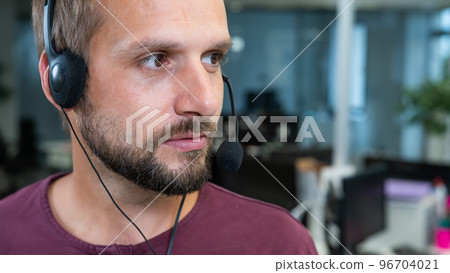 Caucasian bearded man with a headset. Male call center worker Caucasian bearded man with a headset. Male call center worker 96704021