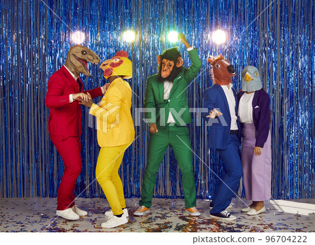 Group of showmen fool around and dance in a club on a shiny blue background. 96704222
