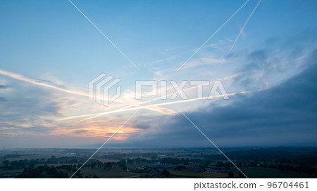 Aerial view of an evening sky over the fields overcast with thunder storm clouds coming in on the Aerial view of an evening sky over the fields overcast with thunder storm clouds coming in on the 96704461