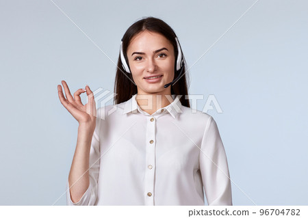 woman in headset is consulting clients online. 96704782