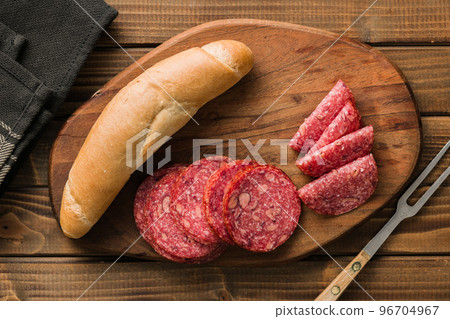 Sliced mexican salami with beans on cutting board. Top view. Sliced mexican salami with beans on cutting board. Top view. 96704967
