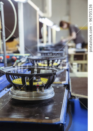 Musical speakers on a conveyor in a factory Musical speakers on a conveyor in a factory 96705136