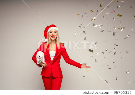 Elegant happy woman in Santa hat with confetti. 96705335