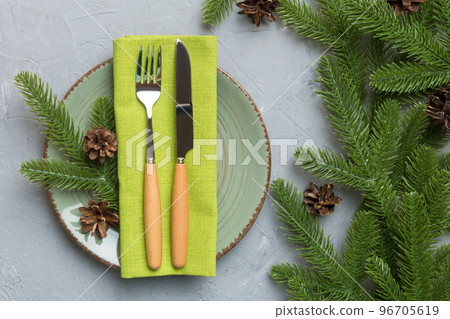 Christmas table place setting with christmas decor and plates, kine, fork and spoon. Christmas holiday background. Top view 96705619
