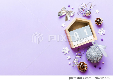 Christmas calendar 1 january. Christmas gift, fir branches, pine cones. Flat lay, top view. New Year decorations on a colored background Christmas calendar 1 january. Christmas gift, fir branches, pine cones. Flat lay, top view. New Year decorations on a colored background 96705680