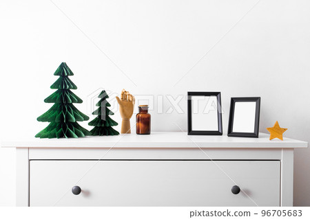 Christmas mock up with black frame and Honeycomb tree paper decor. Square frame on a wooden shelf against a white wall. Copy space. 96705683