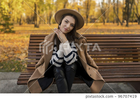 portrait of attractive stylish smiling portrait of attractive stylish smiling woman with long hair walking in the park, dressed in warm brown coat autumn trendy fashion, street style wearing hat portrait of attractive stylish smiling portrait of attractive stylish smiling woman with long hair walking in the park, dressed in warm brown coat autumn trendy fashion, street style wearing hat 96707419