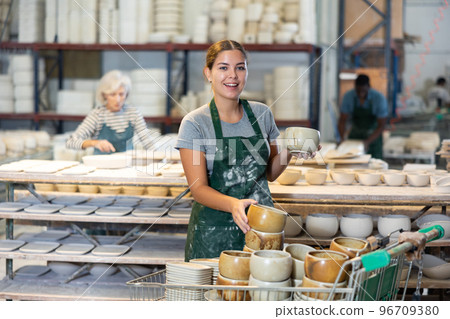 Cheerful young woman ceramist in workshop 96709380