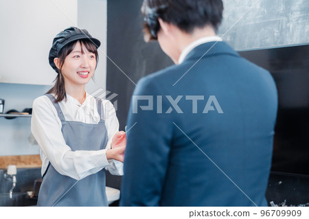 Male customer making credit card payment at cafe 96709909