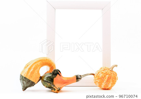 Decorative pumpkins and an empty frame on a white background 96710074