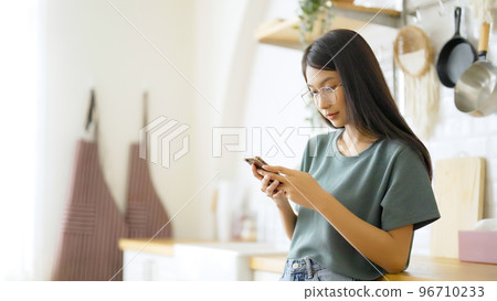 Happy young asian woman wearing glasses and relaxing at home 96710233