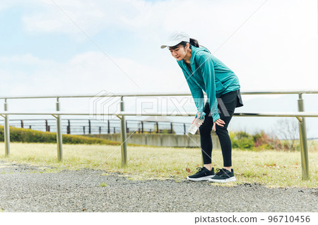 Asian woman in sportswear suffering from shortness of breath, fatigue and dizziness during running and walking Asian woman in sportswear suffering from shortness of breath, fatigue and dizziness during running and walking 96710456